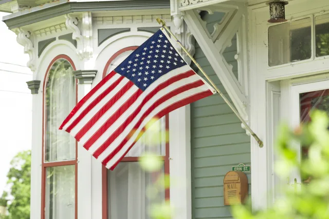 American flag flying from a front porch